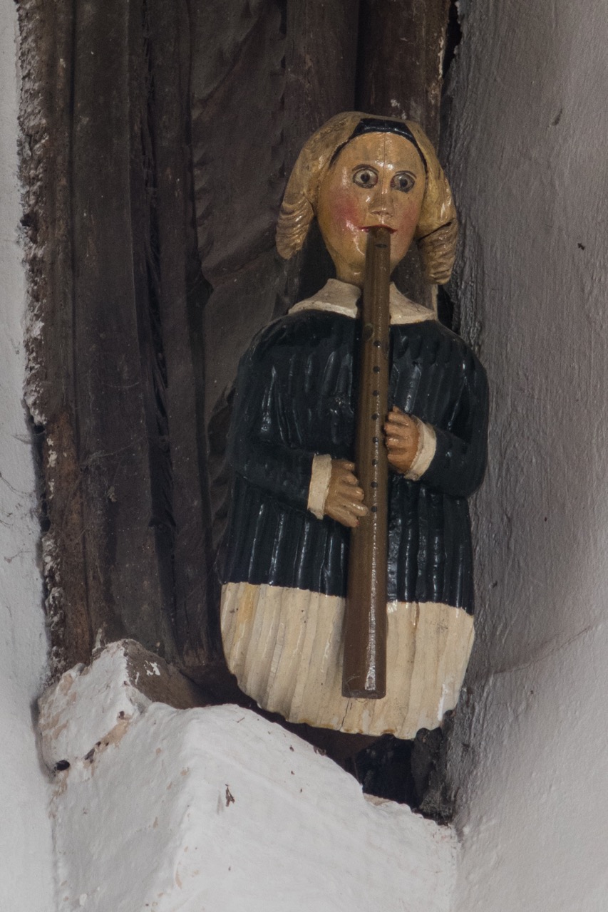 Figure of a flute player in the chancel (late 15th cent.)