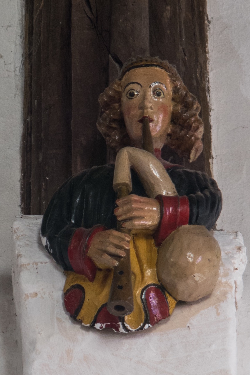 Figure of a bagpipe player in the chancel (late 15th cent.)