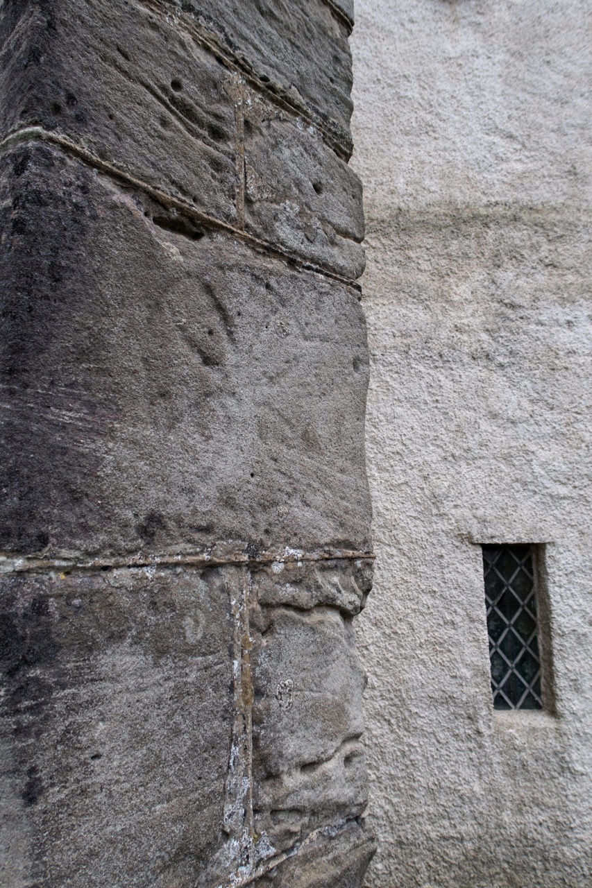 Consecration cross on the north-western buttress of the nave