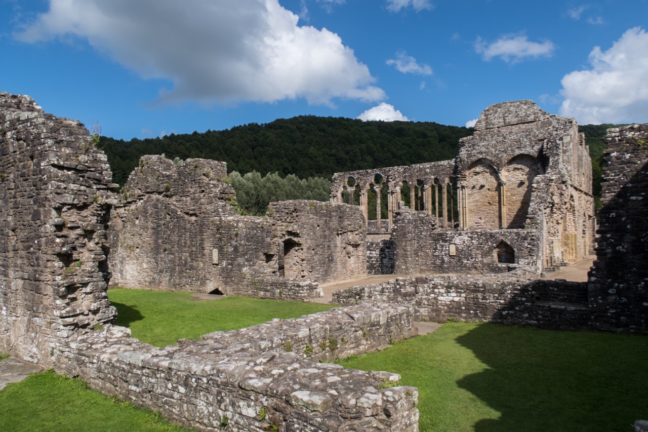 Abbey buildings at the western edge of the area (“west range”), with window arches of the refectory in the background