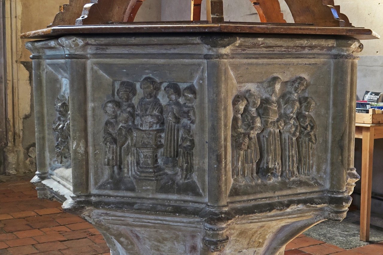Octagonal font (c. 1460), panels showing the sacraments of Baptism (left) and Confirmation (right)