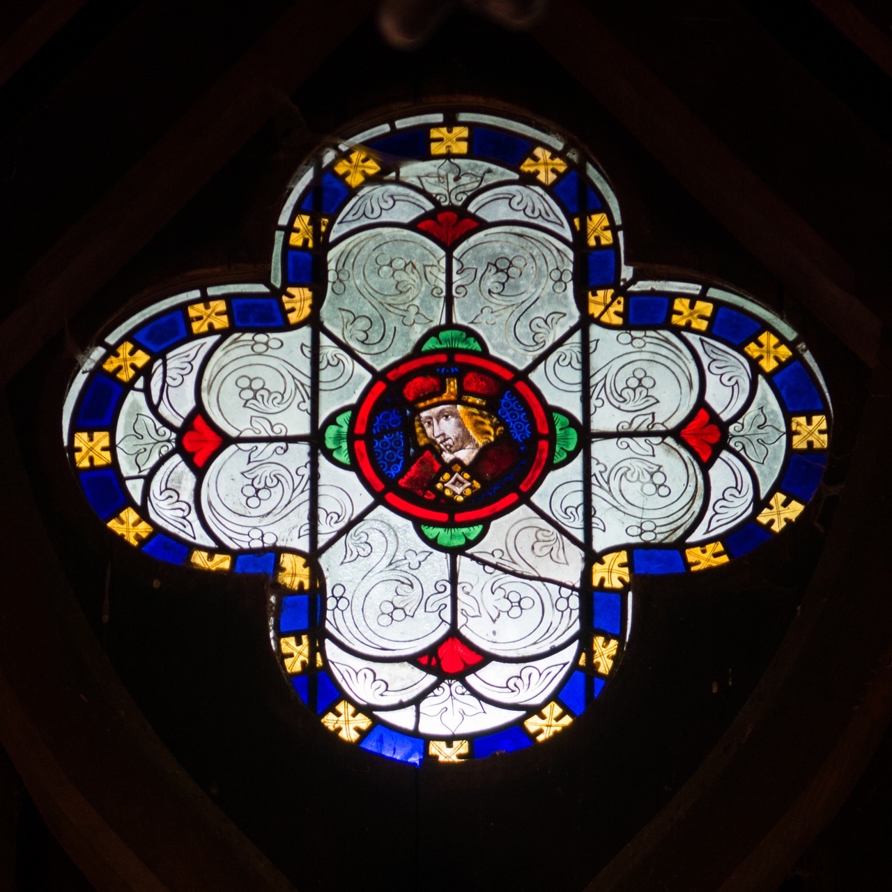 Quatrefoil window at the west end of the nave (containing a glass fragment from the 15th cent.)