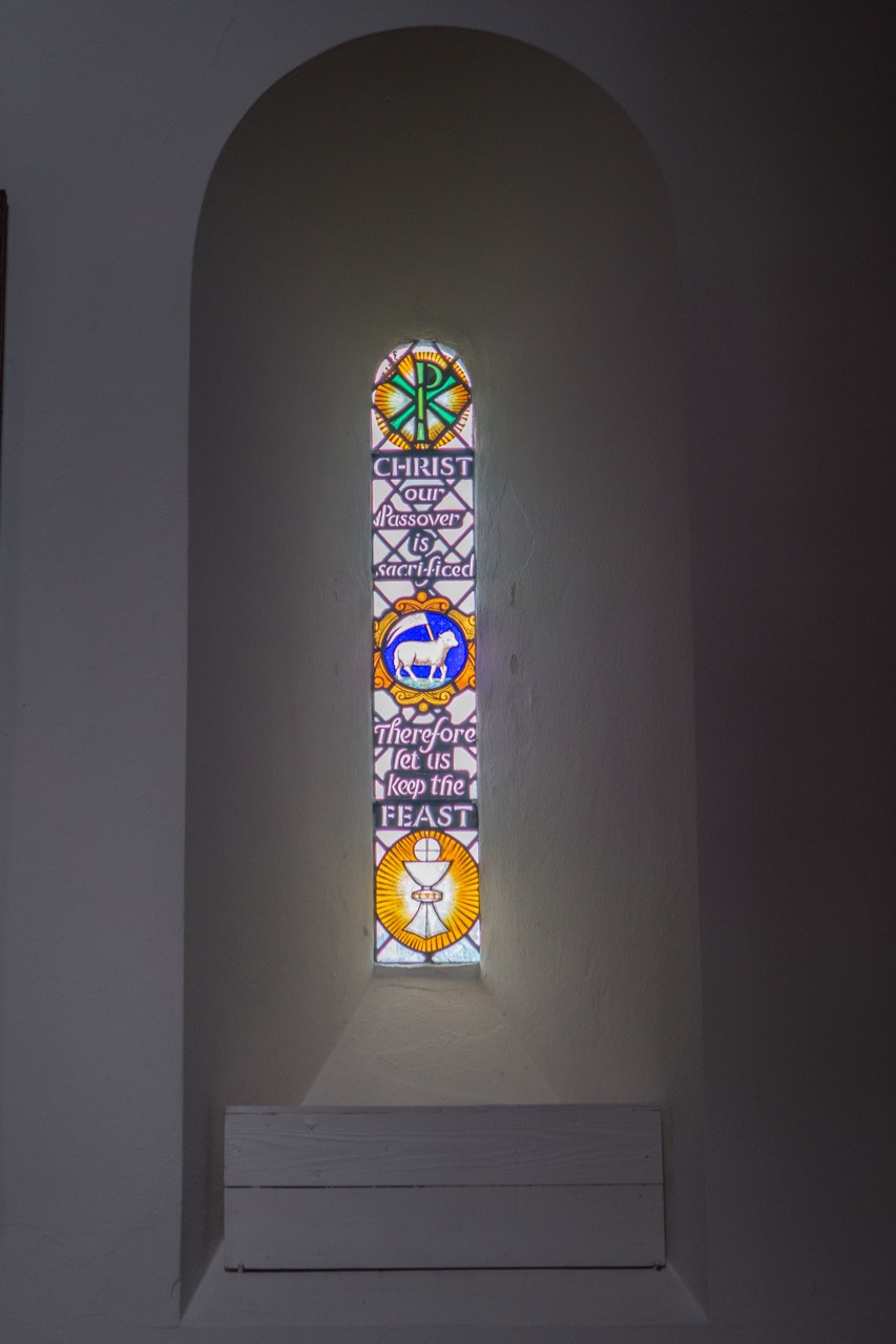 Norman rounded window arch in the chancel (modern glass pane)