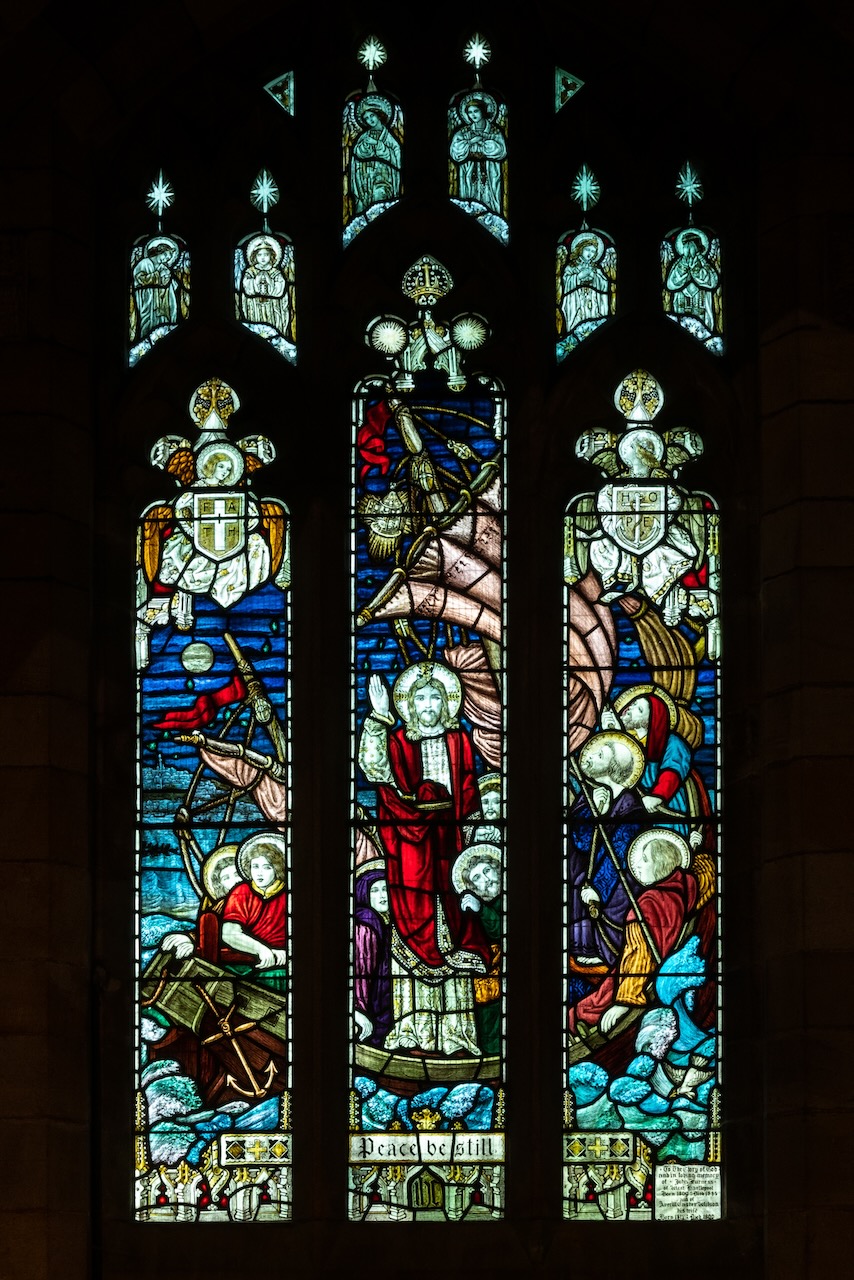 Stained glass window showing the miracle of Jesus stilling the storm