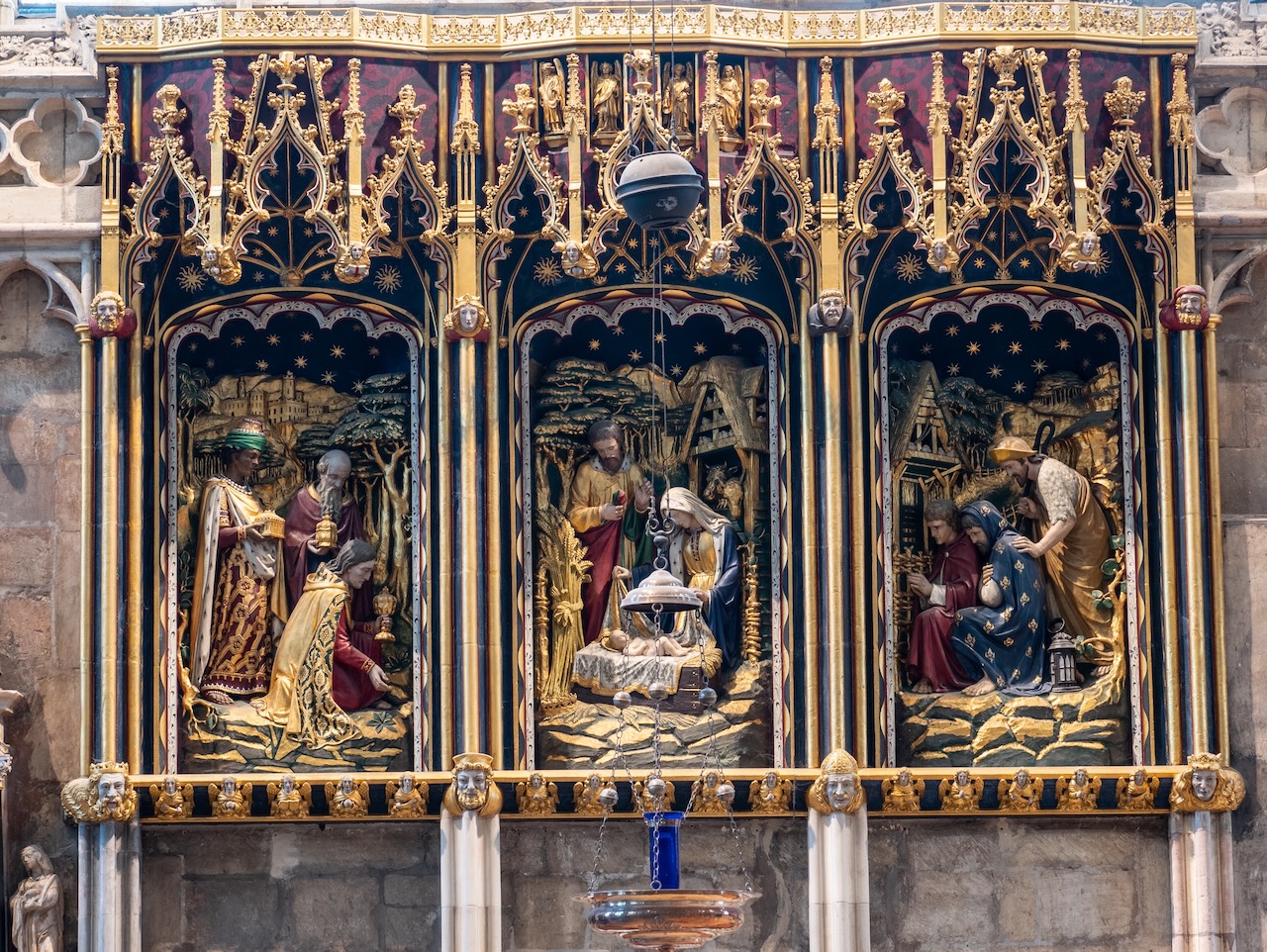 Lady Chapel, reredos (1905) showing a Nativity scene with the Magi (left) and shepherds (right)